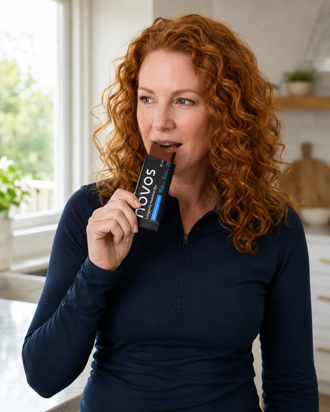 Woman enjoying a NOVOS Bar in a bright kitchen