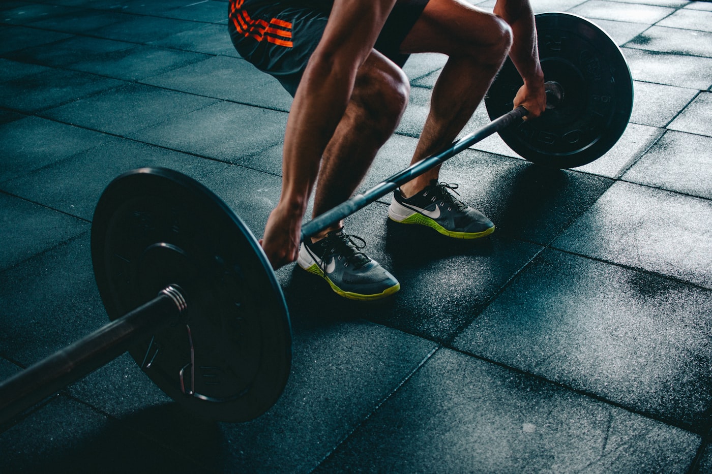 Athlete preparing to lift a barbell in a gym