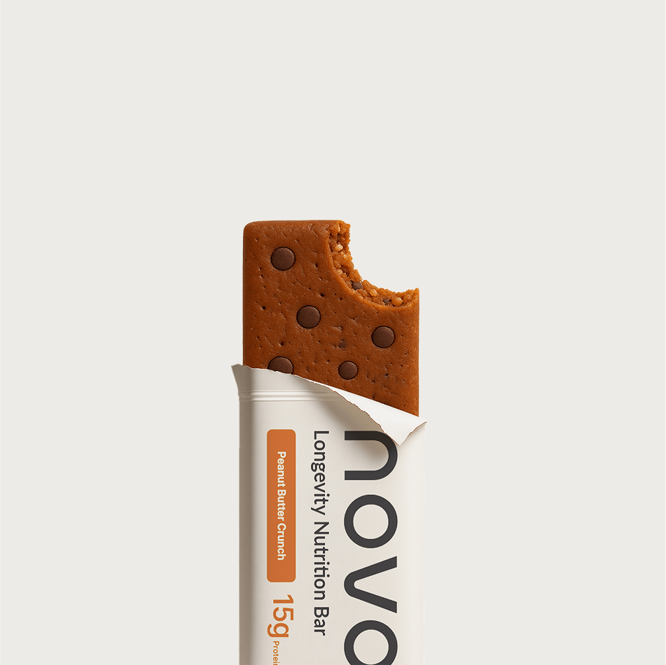 Close up of the NOVOS Bar unwrapped, showing its dense extruded texture with chocolate pieces