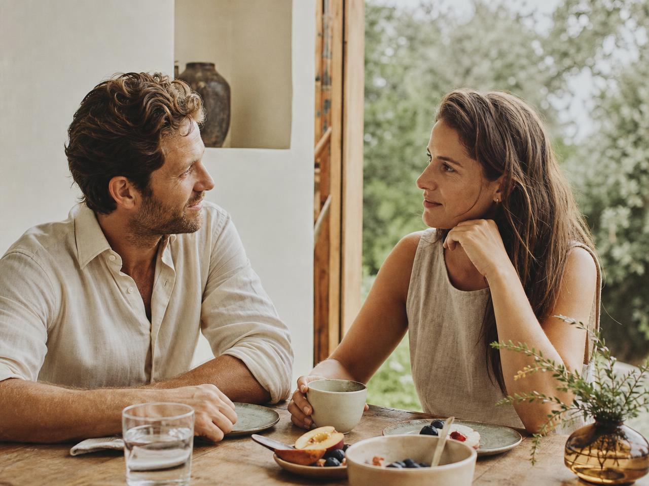 Two people in their thirties sharing an unhurried breakfast in natural light