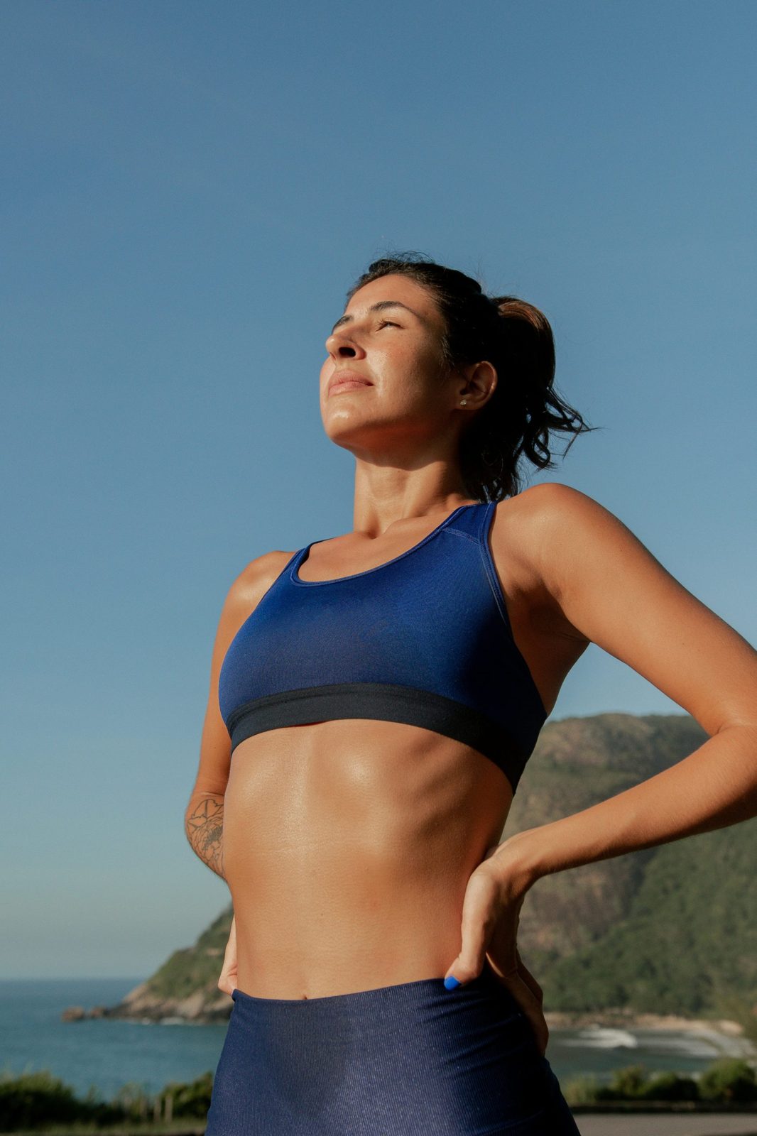A woman breathing deeply after exercise in the open air