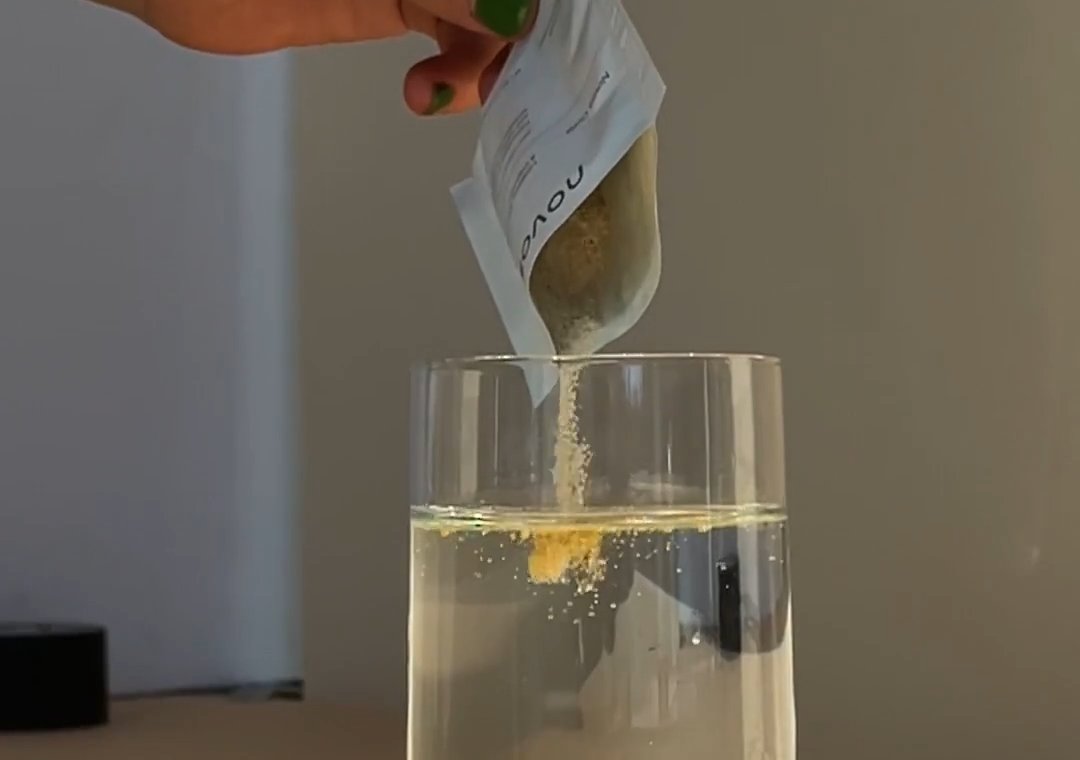 NOVOS Core being poured into a glass of water