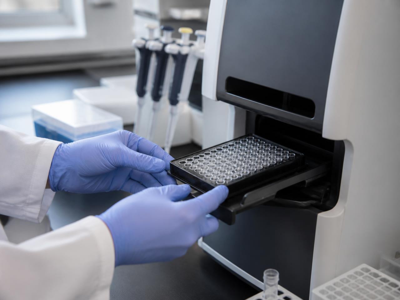 Researcher loading a sample plate for DNA methylation analysis